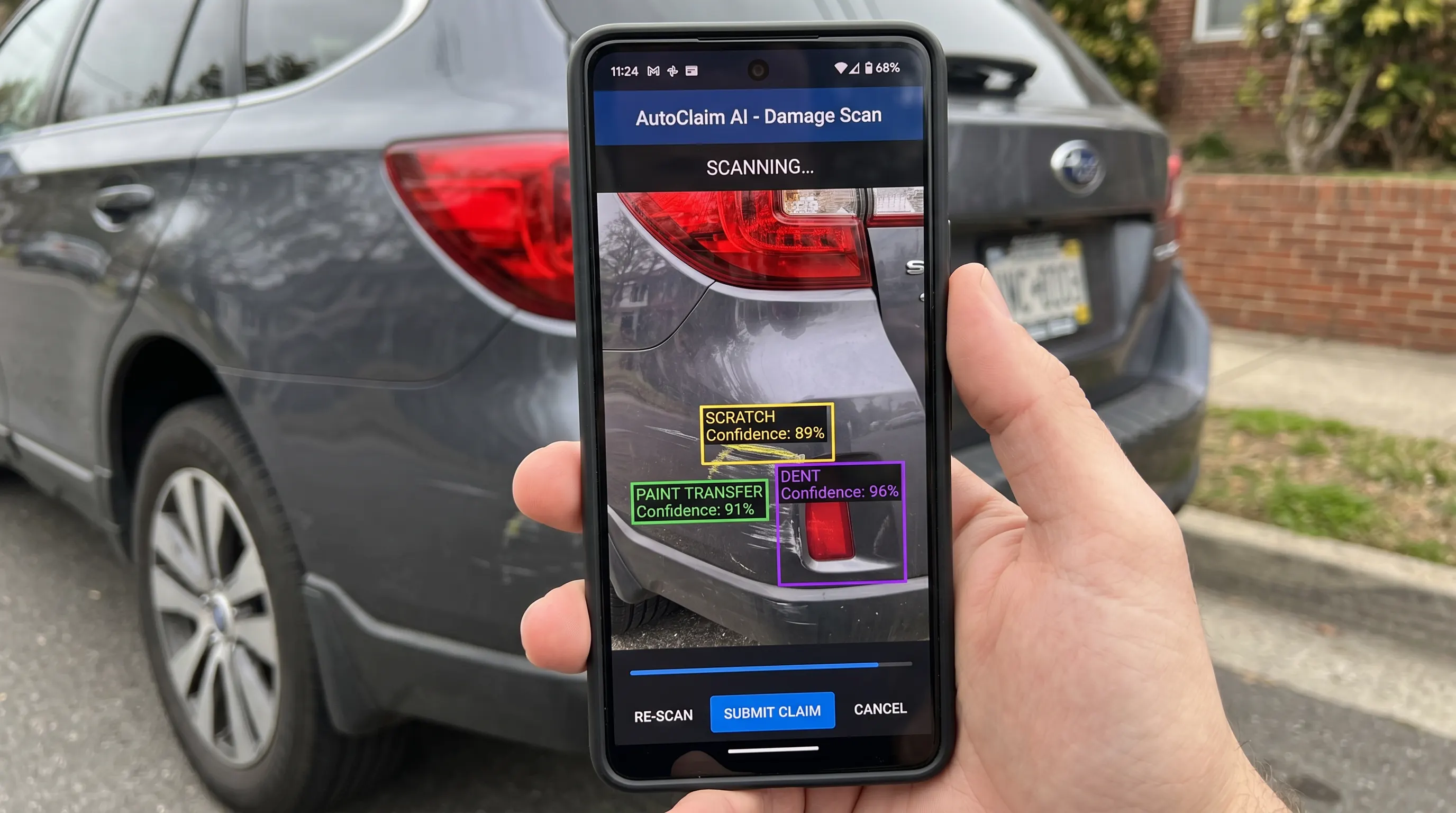 Close-up view of a smartphone screen showing an AI damage detection interface scanning a car's damaged rear…